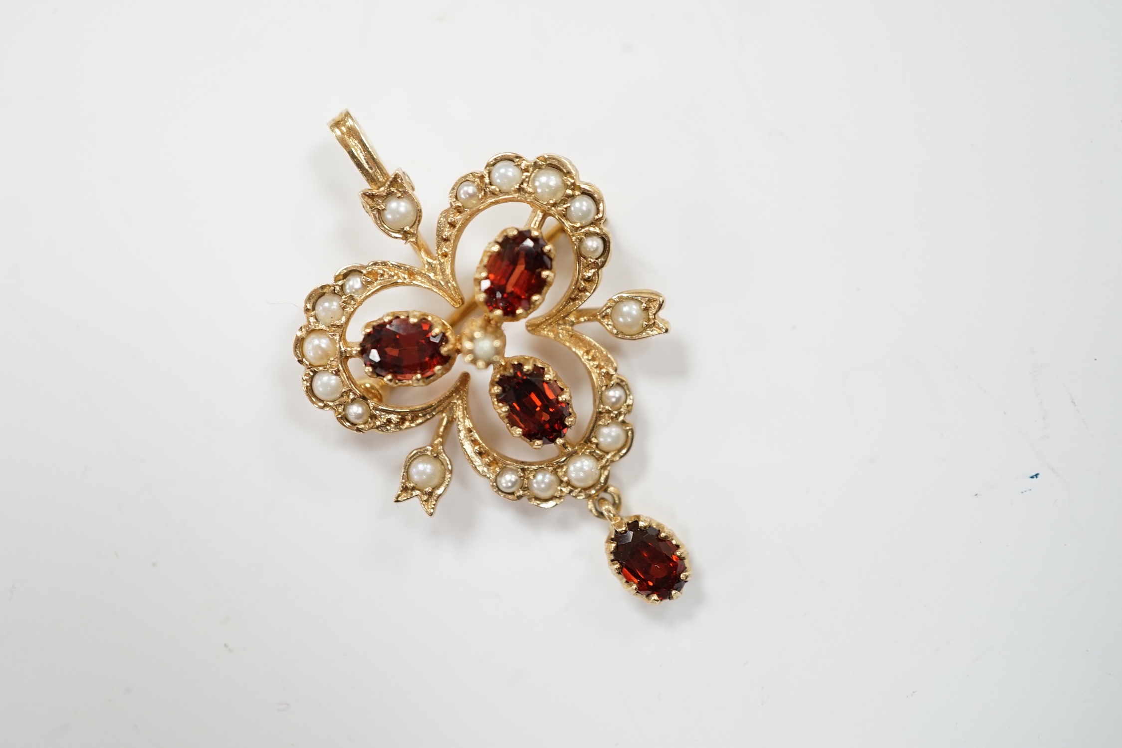 A modern 9ct gold garnet and seed pearl cluster set drop pendant brooch, 39mm, gross weight 4.8 grams.